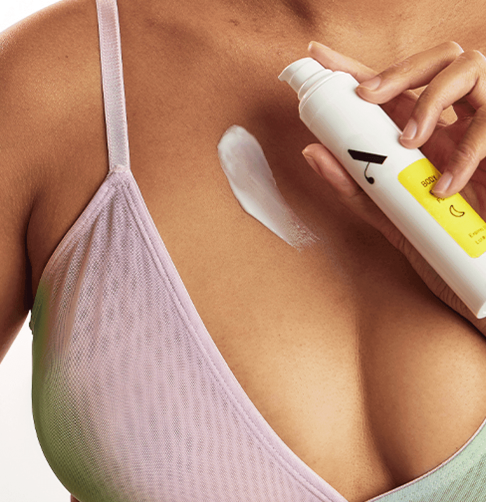 Woman applying acne body lotion to her chest acne.
