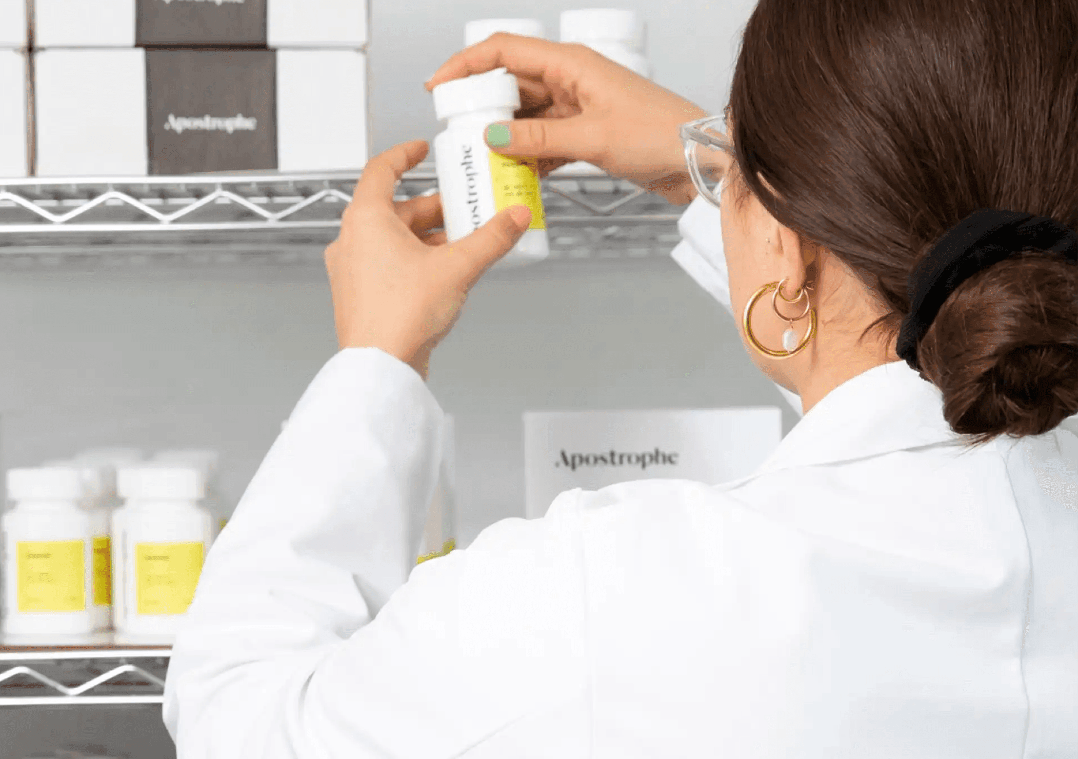 Apostrophe pharmacist checking bottles